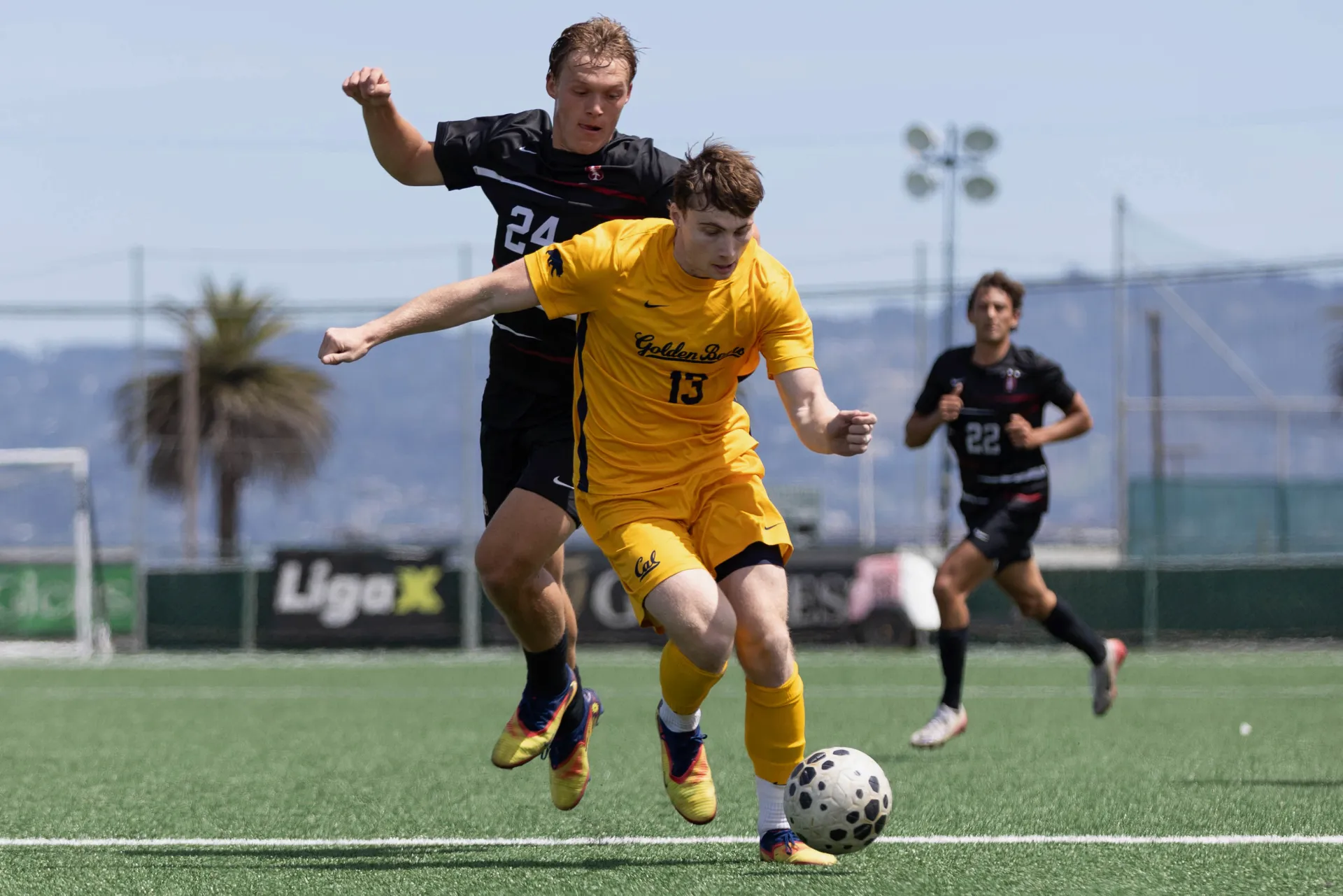 Kai in the Cal kit, dribbling past Stanford